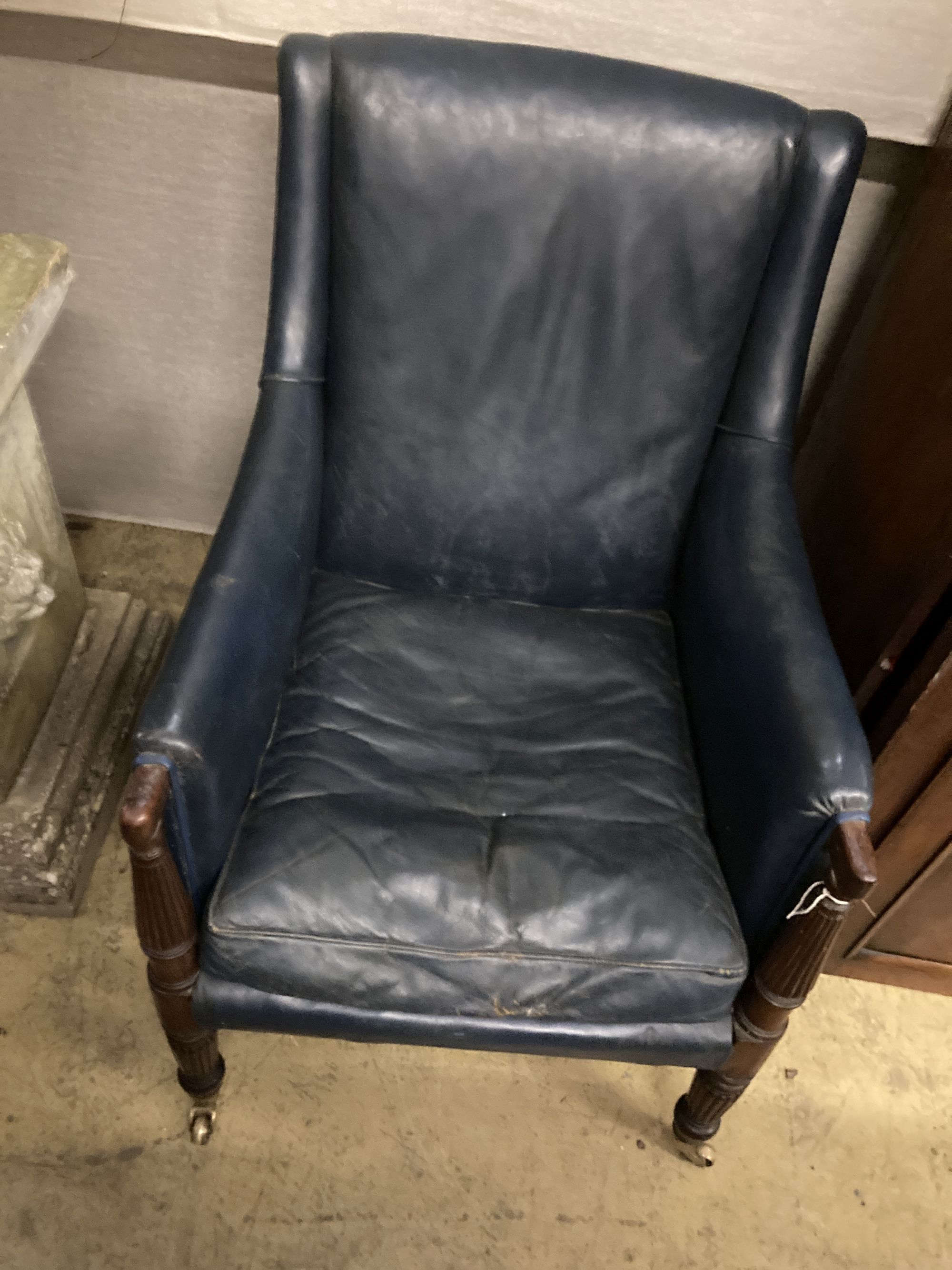 A Regency mahogany library chair, upholstered in blue leather, width 65cm depth 75cm height 93cm